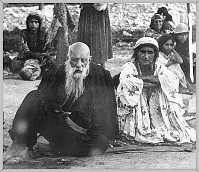 Gypsy couple sitting in an open area in the Belzec concentration camp